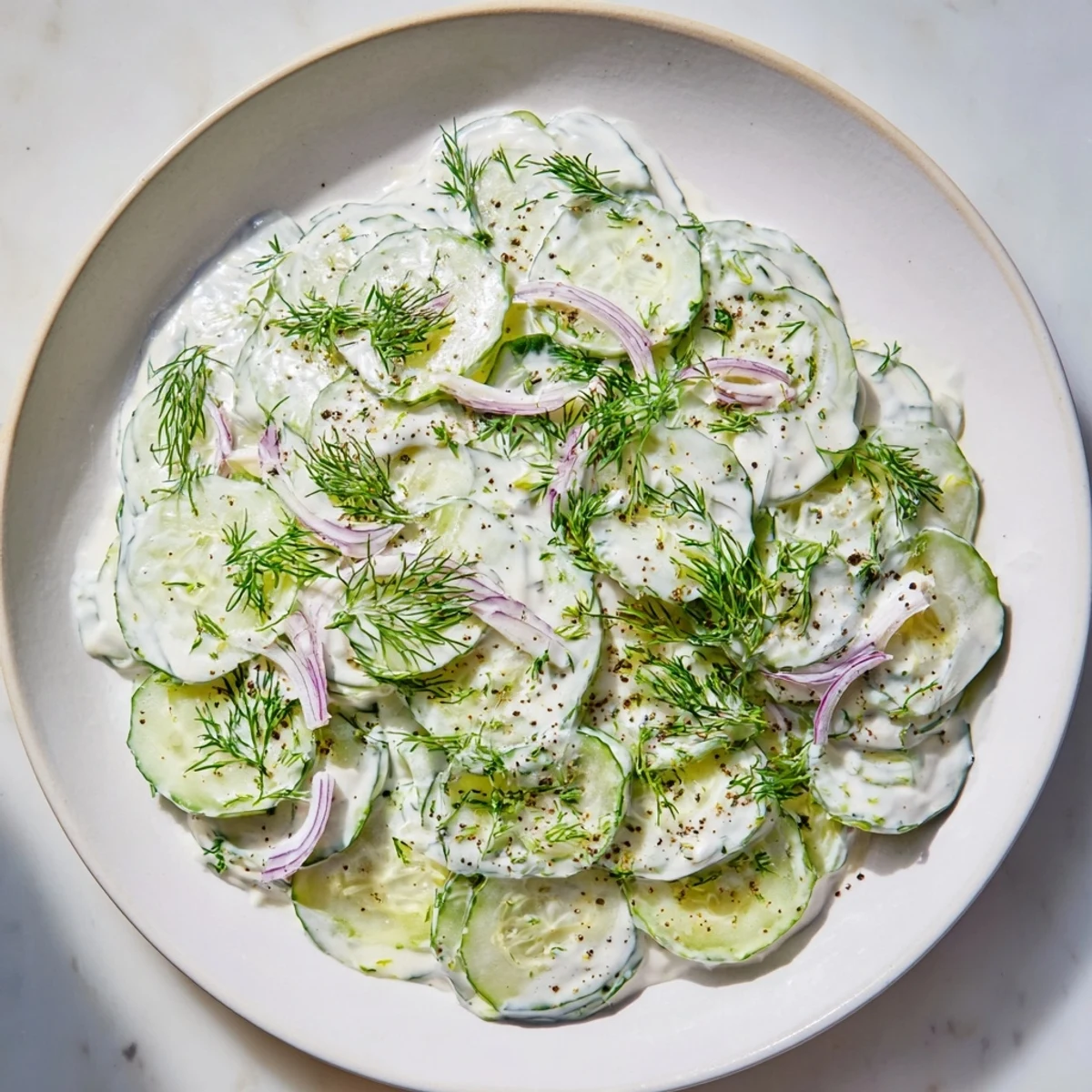 Creamy Omas German Cucumber Salad, with fresh dill, ready to eat, a perfect side dish.