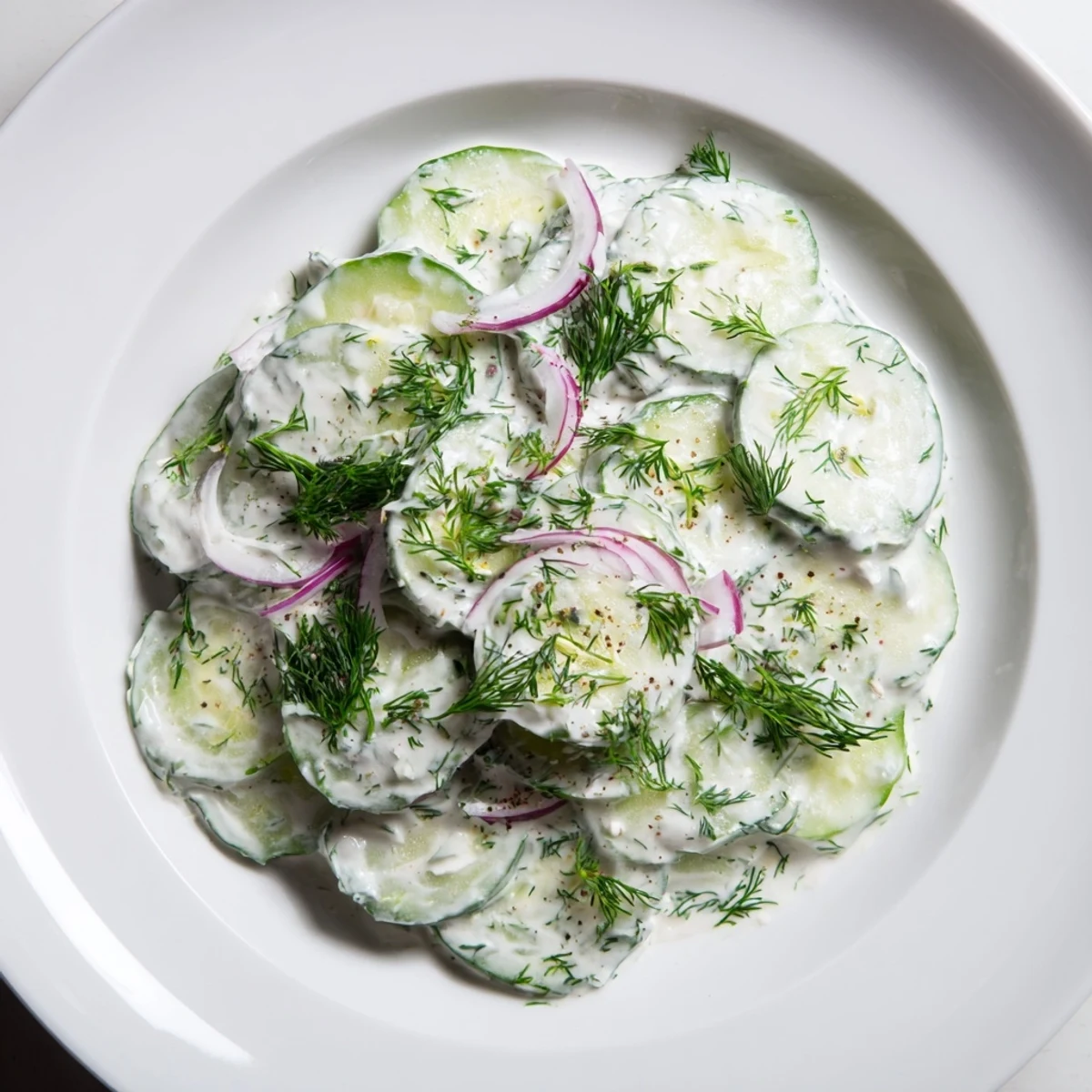 A vibrant bowl of Omas German Cucumber Salad, showing a refreshing, summer side idea.
