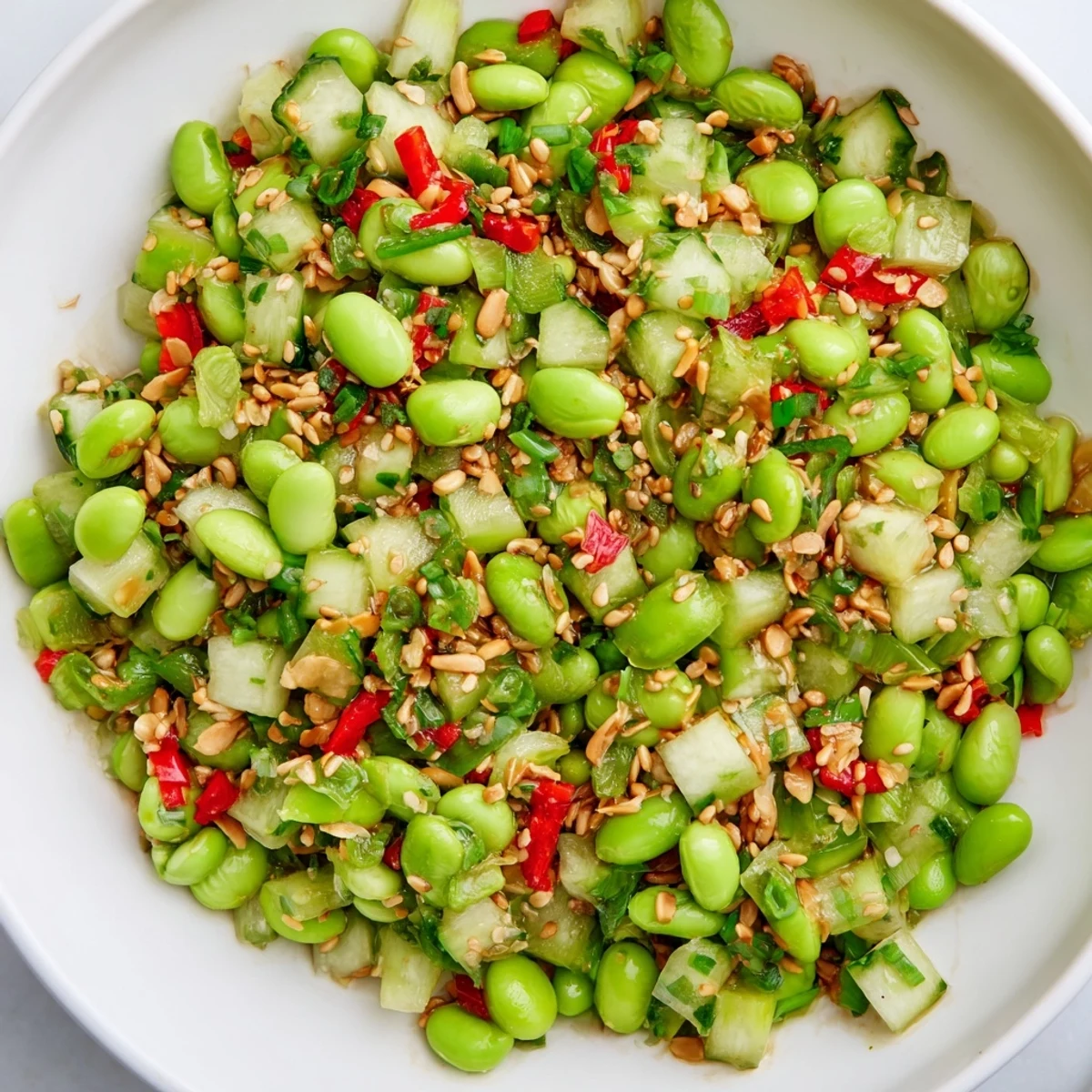 Vibrant Edamame Salat: fresh edamame and crisp cucumber, tossed invitingly in a sesame dressing.