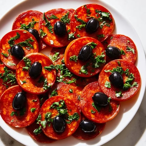 Sizzling pepperoni slices topped with salty olive halves—a colorful, quick Sliced Pepperoni and Olive Halves appetizer.