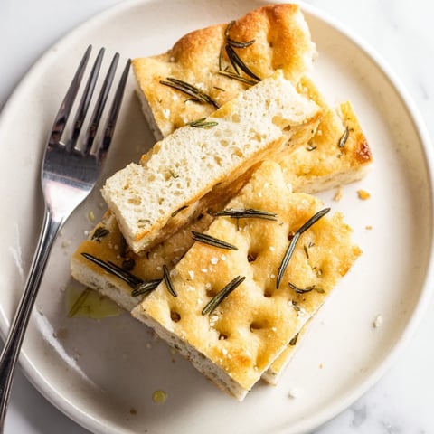 Golden, crisp slices of Holiday Bread focaccia topped with fresh rosemary and sea salt.