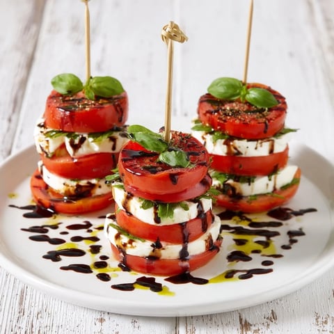 Elegant Tuscan Pillar appetizer with ripe tomatoes, creamy mozzarella, and balsamic glaze.