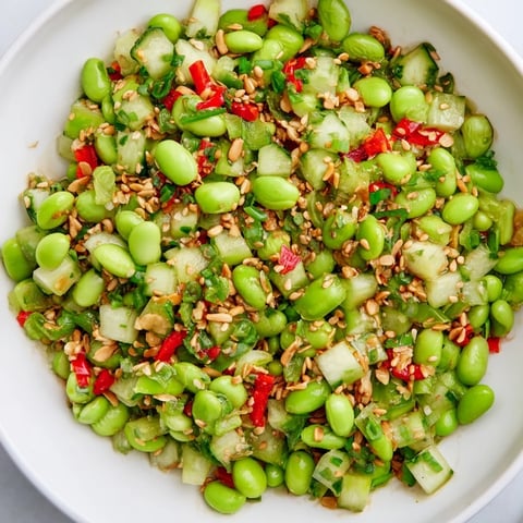 Vibrant Edamame Salat: fresh edamame and crisp cucumber, tossed invitingly in a sesame dressing.