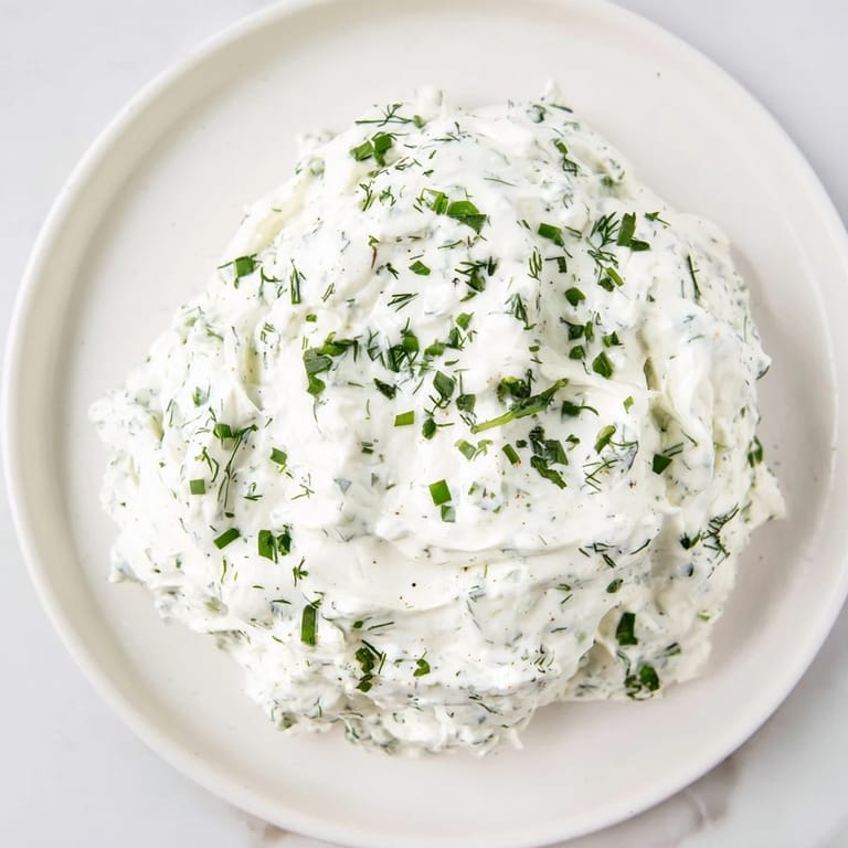 Close-up of a flavorful Greek yogurt ranch dip, served with colorful veggie sticks, an American favorite.