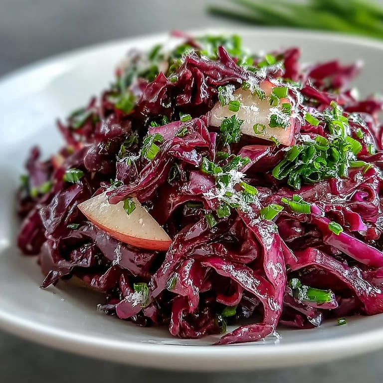 A bright serving of Red Cabbage Coleslaw With Apple and Parmesan, ready for a summer BBQ plate.